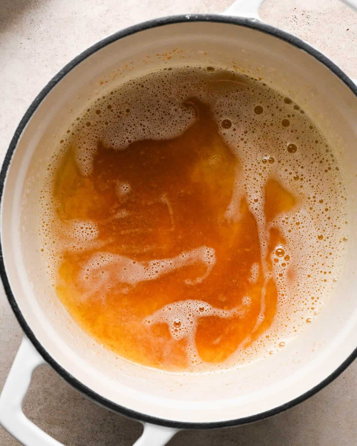 browning butter to make brown butter pumpkin cookies - browned butter in a white pot