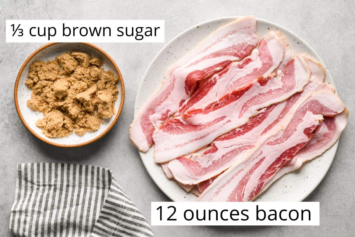 Overhead photo of the ingredients for brown sugar bacon: a bowl of brown sugar and a plate of uncooked bacon are sitting on a light gray surface.