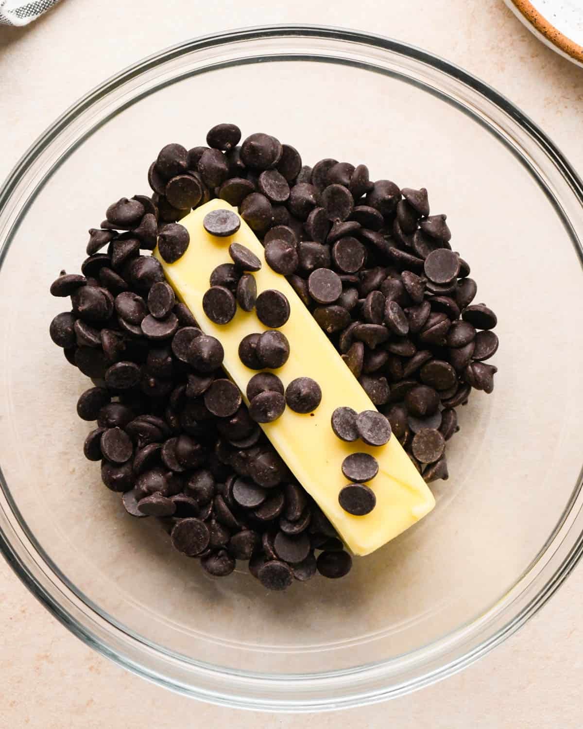making brownie bites - chocolate chips and butter in a glass bowl before melting