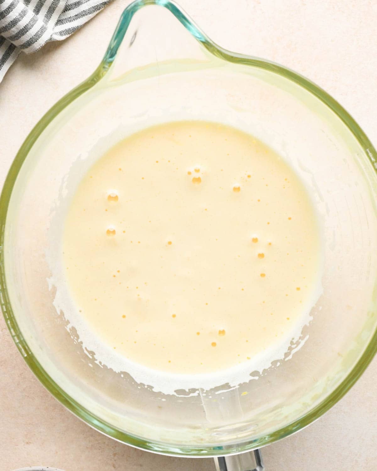 making brownie bites - eggs and sugar beaten together in a glass mixing bowl