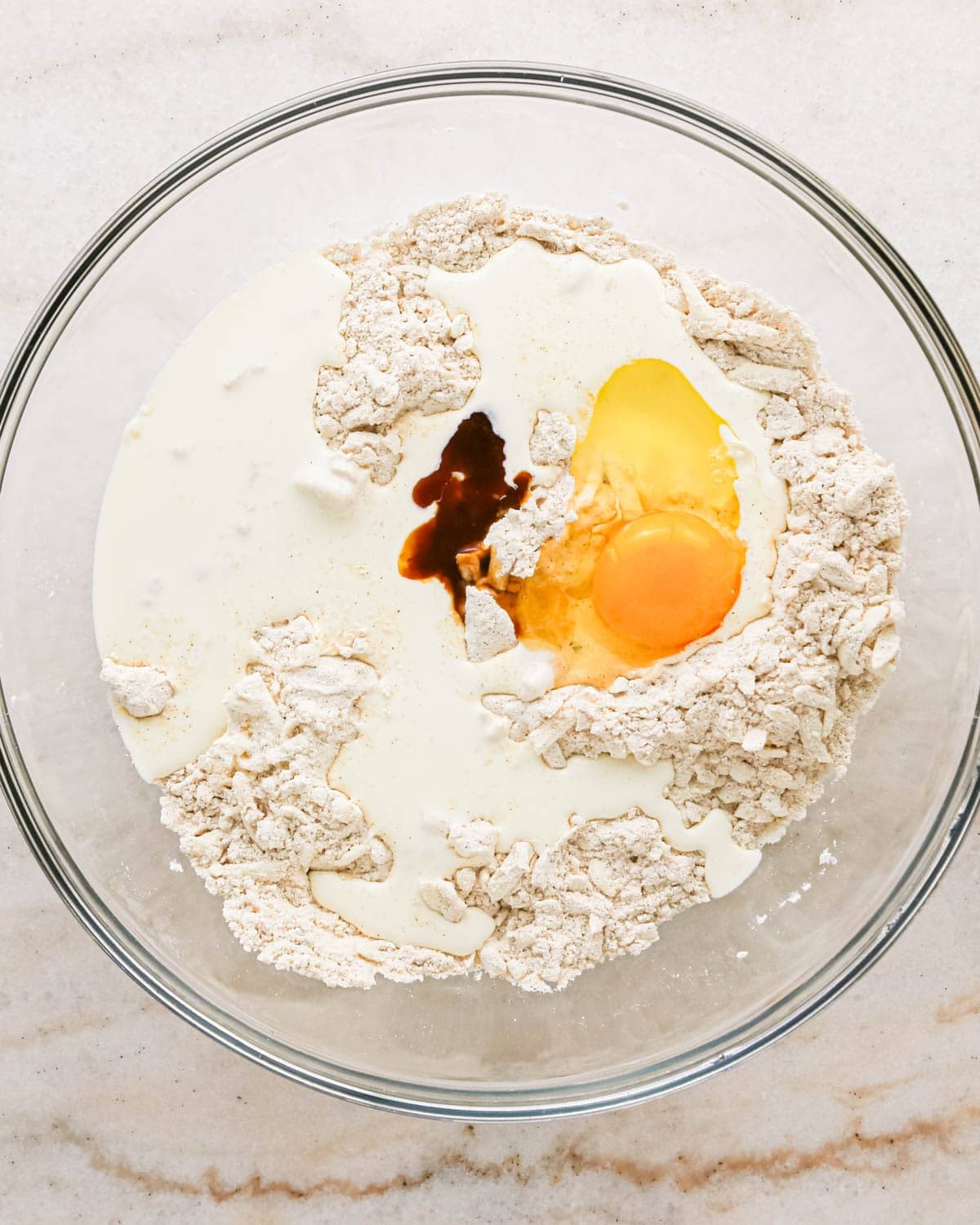 making apple scones - egg, vanilla and half and half added to the scone mixture before mixing