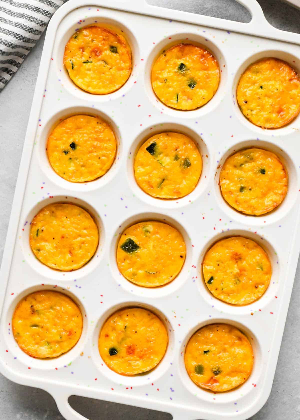 cottage cheese egg bites mixture in a white silicone muffin pan after baking