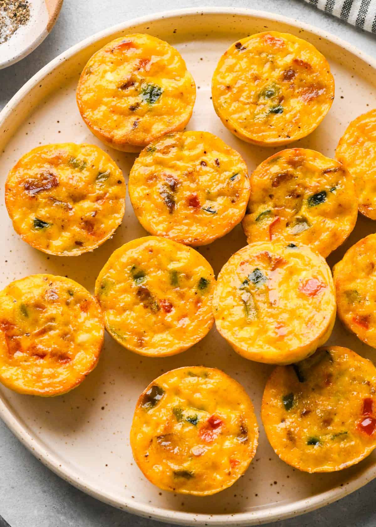 12 cottage cheese egg bites on a speckled pottery plate