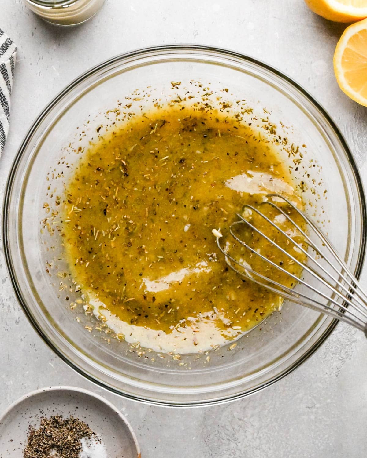 Italian dressing being whisked in a glass bowl