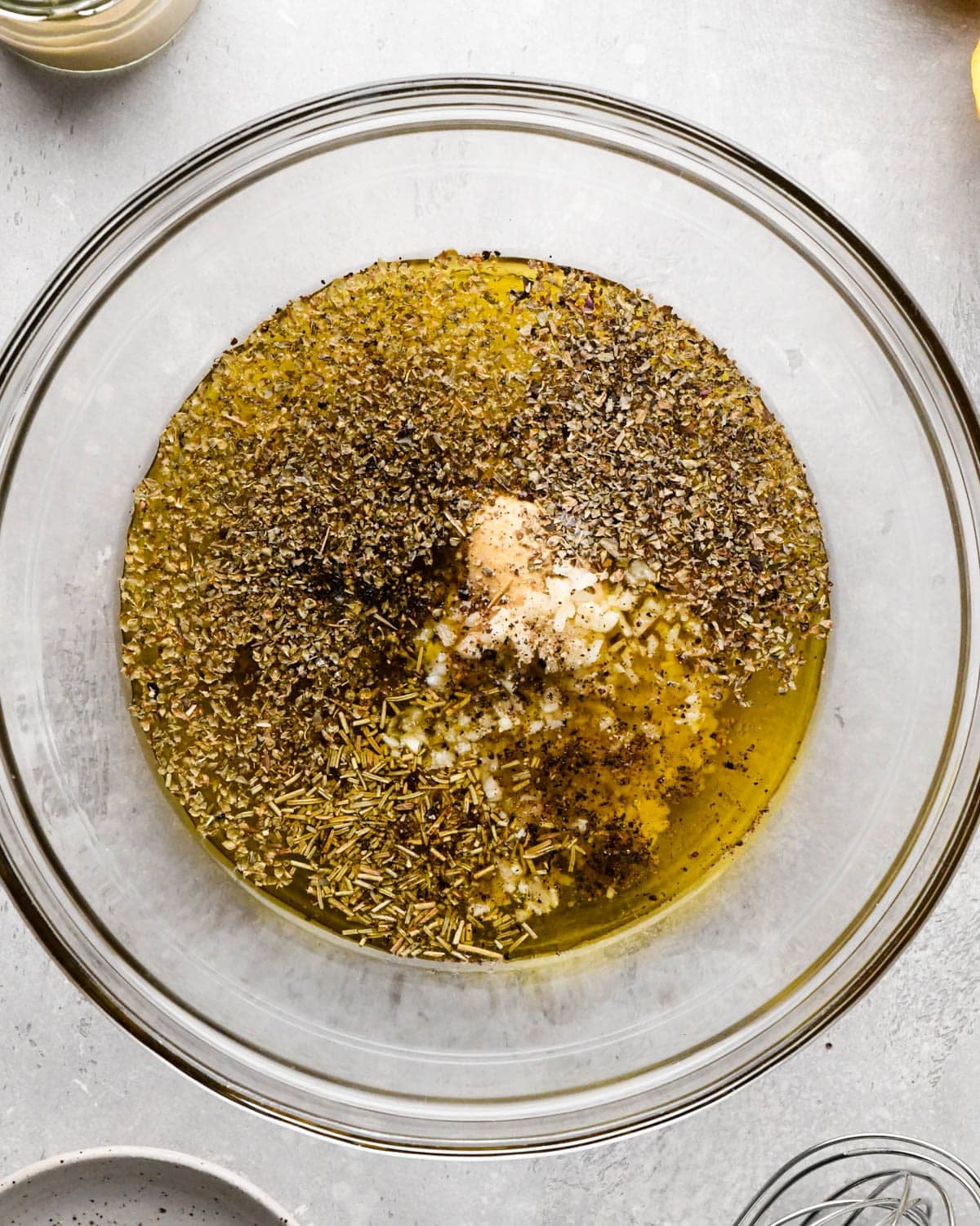 all the ingredients for this italian dressing recipe in a glass bowl before mixing