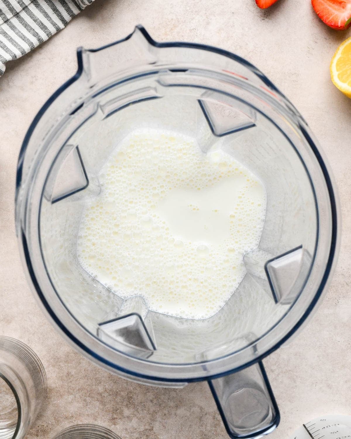 making a strawberry smoothie - milk in a blending container