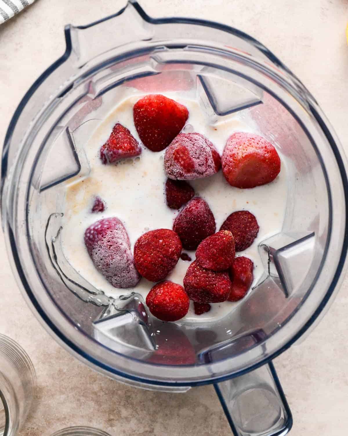 making a strawberry smoothie - all the ingredients in a blending container before blending