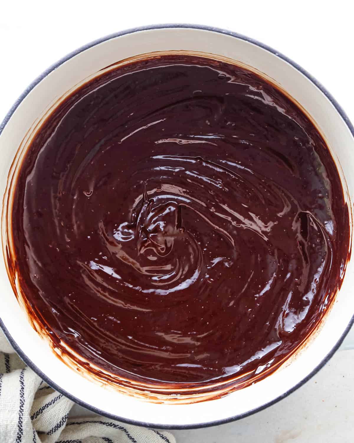 making chocolate glaze in a white pot