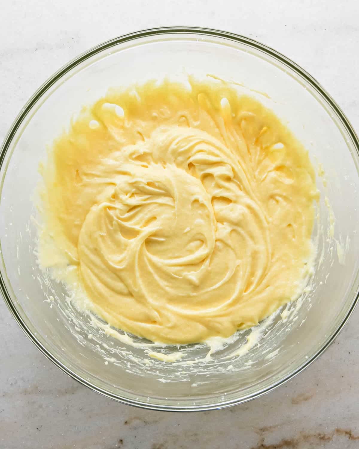 making strawberry cake - wet ingredient mixture beaten in a glass bowl