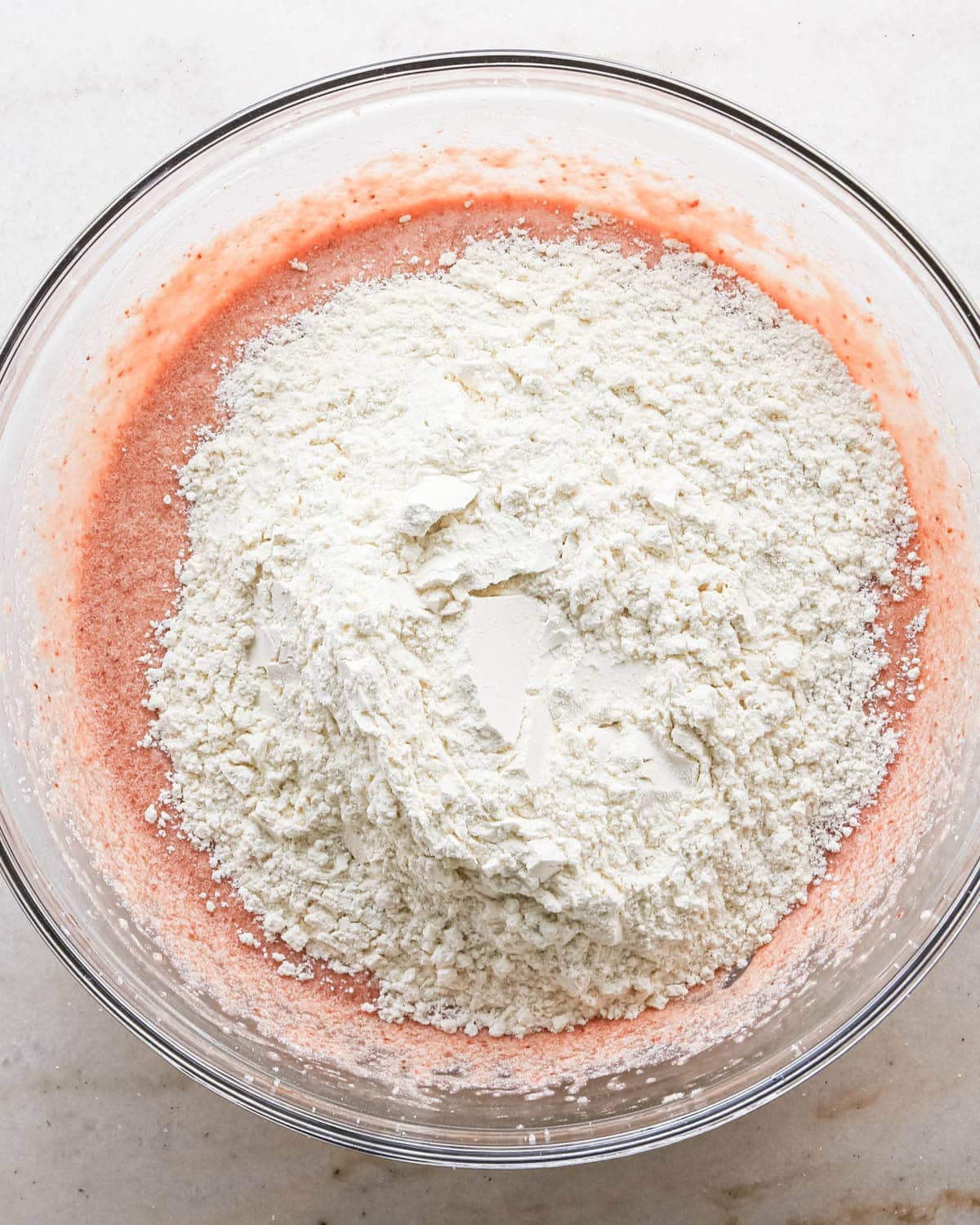 making strawberry cake - dry ingredients added to the wet ingredients before mixing