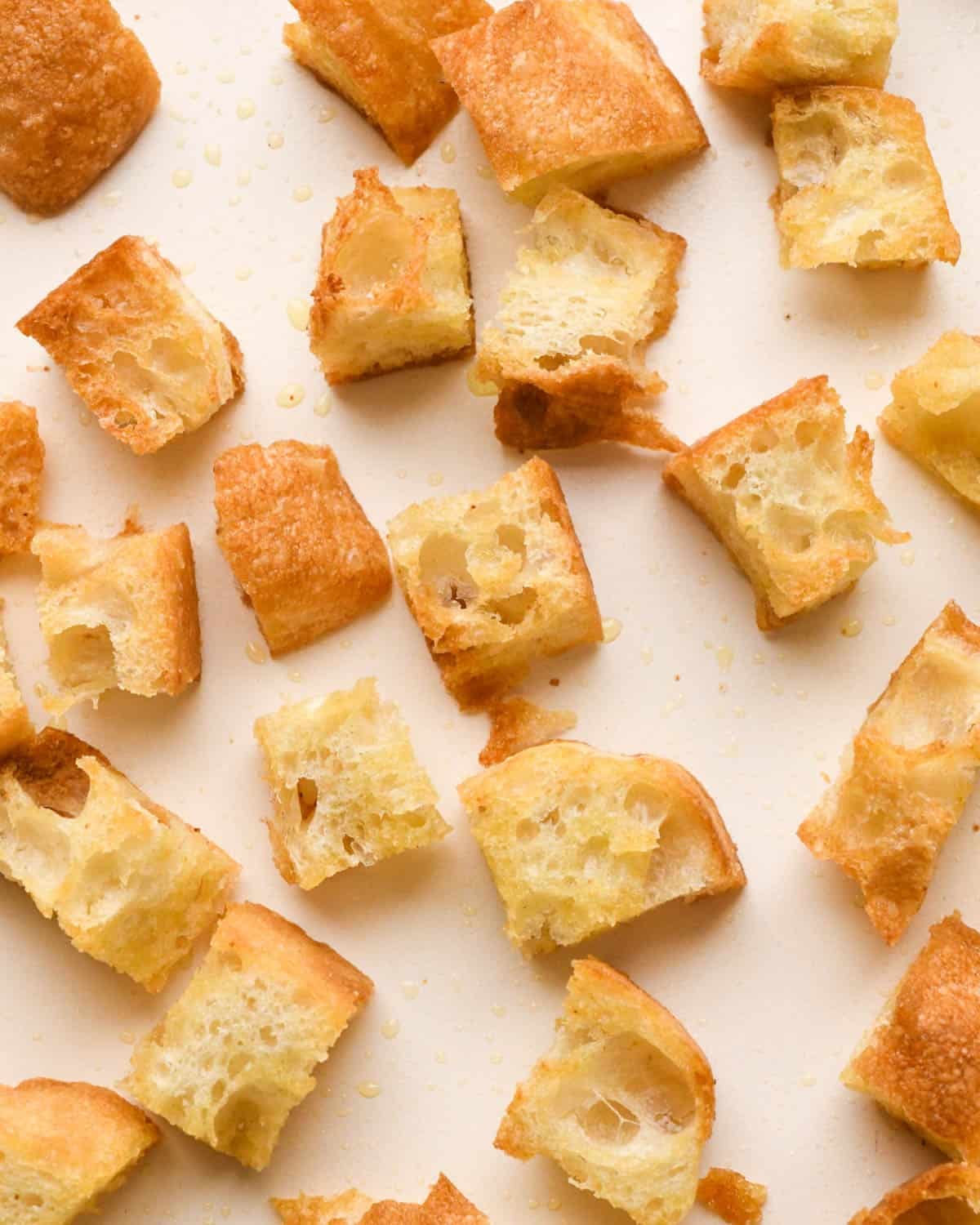 making croutons for Italian salad - up close photo of finished baked croutons on a baking sheet