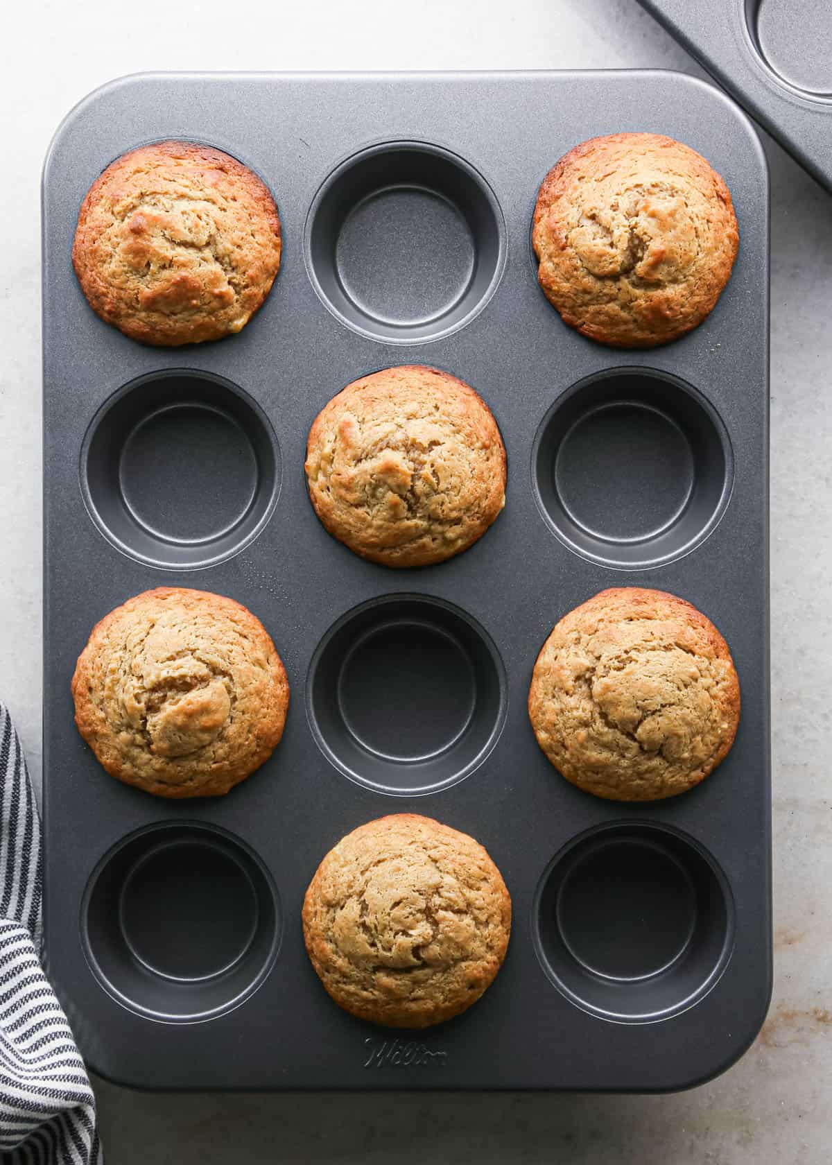 making peanut butter banana muffins - 6 baked muffins in a muffin pan
