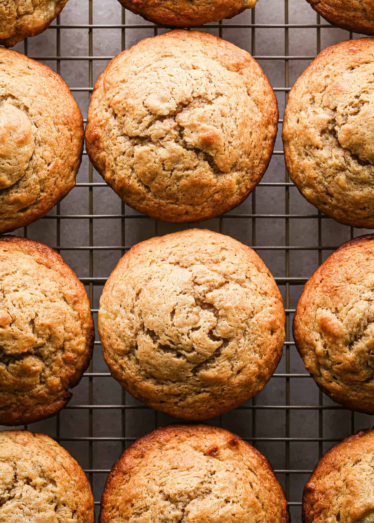 9 peanut butter banana muffins on a wire cooling rack