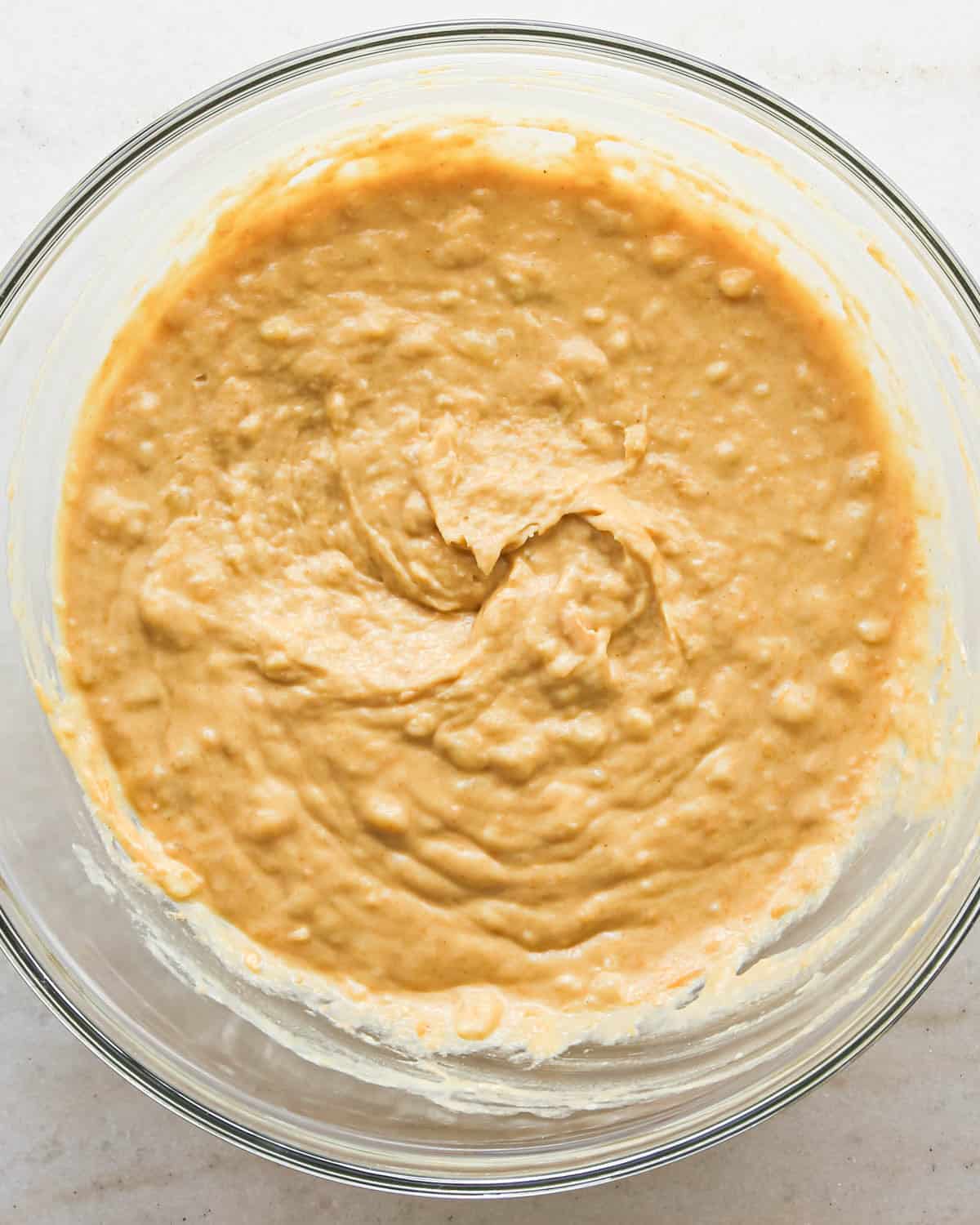 making peanut butter banana muffins - wet ingredients mixed together in a glass bowl