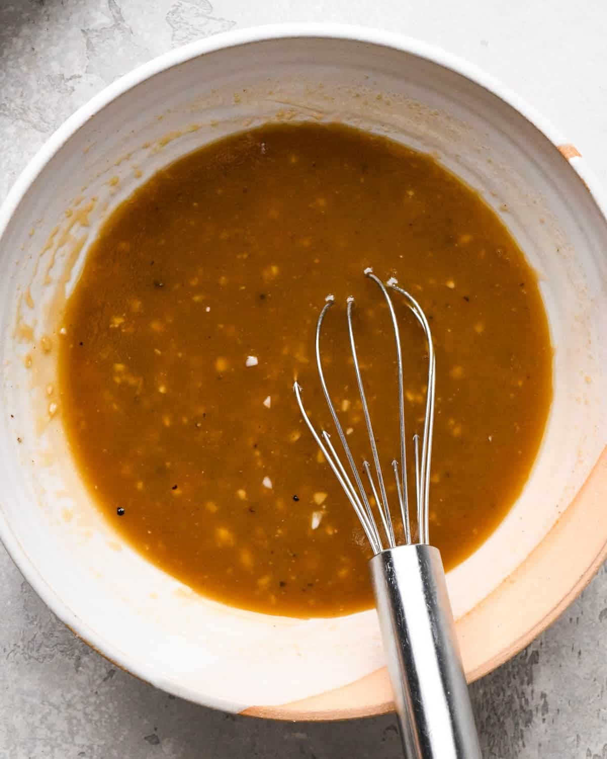 how to make pear salad - dressing in a small bowl with a wire whisk