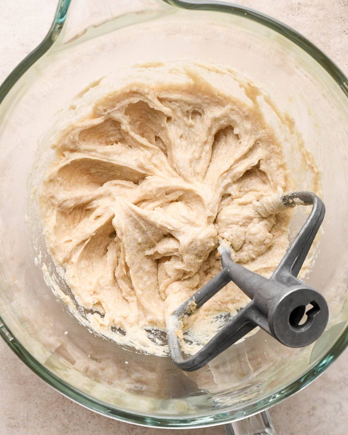 making vegan oatmeal cookies - wet ingredients beat in a glass mixing bowl with the paddle attachment
