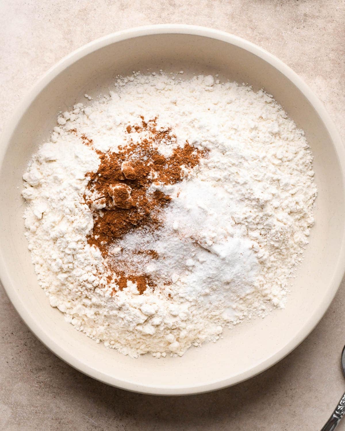 making vegan oatmeal cookies - dry ingredients in a white bowl before mixing