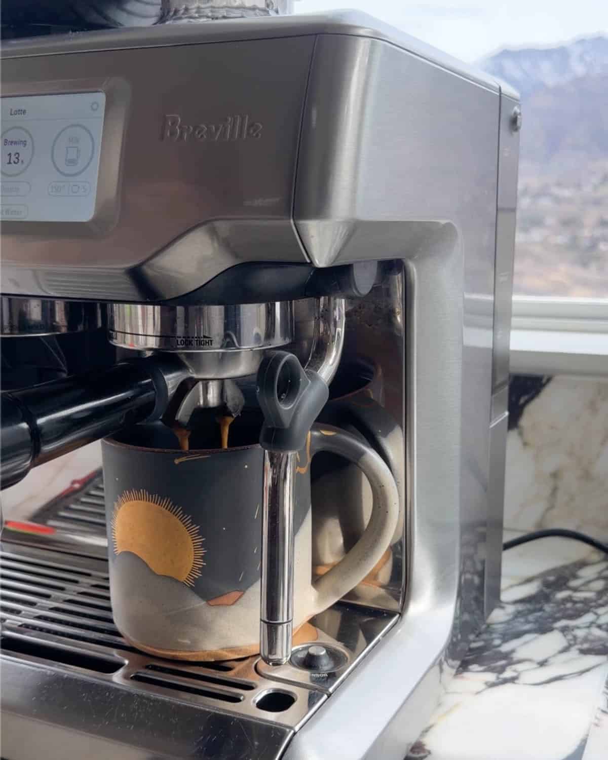 how to make a latte - espresso shots brewing into a mug