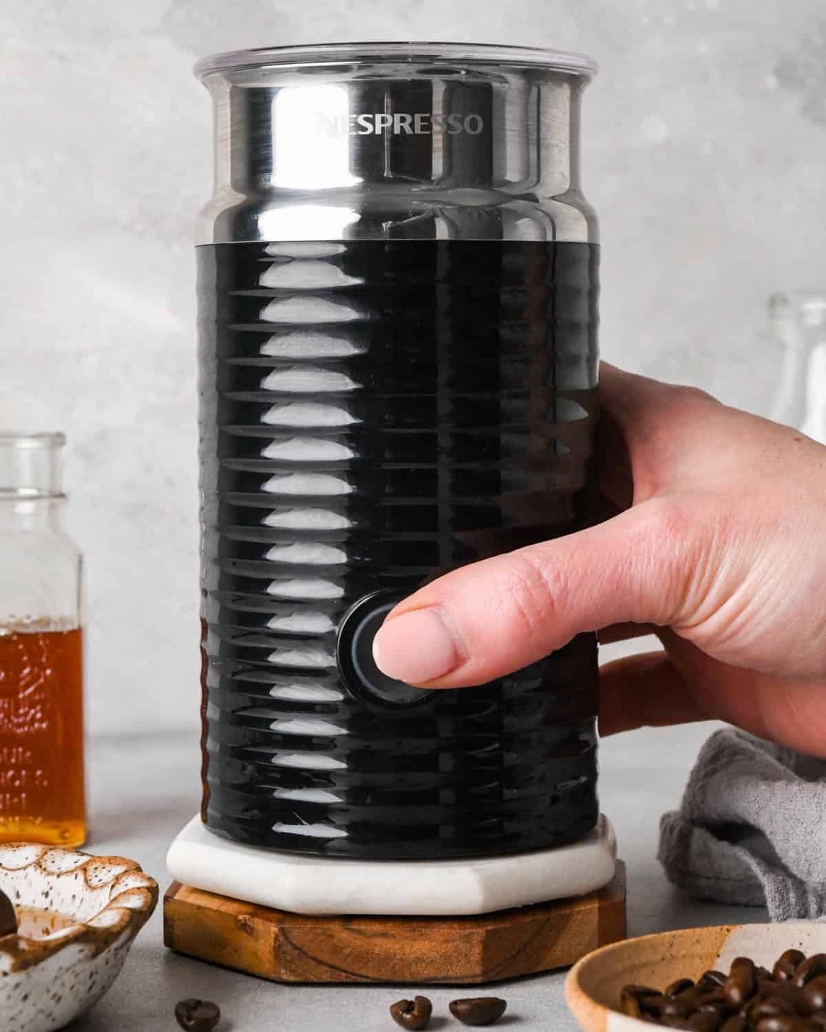 How to make a latte: front-view photo of espresso and honey being mixed together.