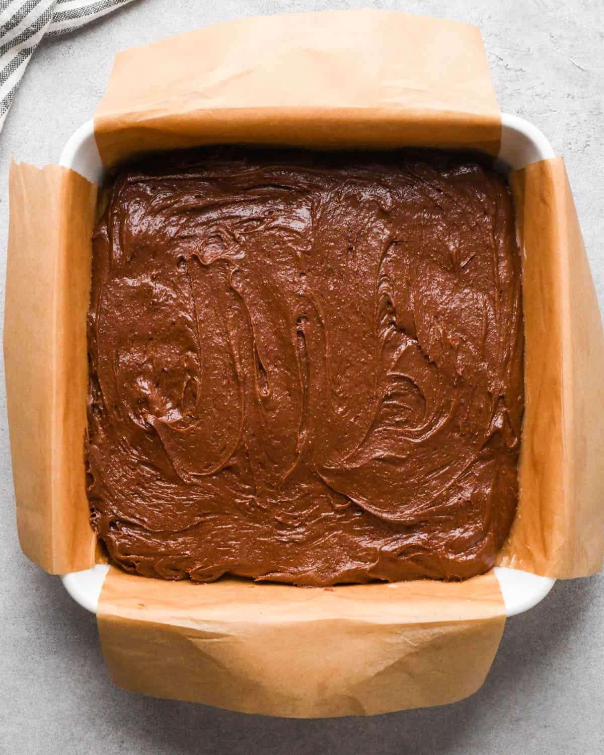 Making buckeye brownies: overhead photo of brownie batter poured into and spread in the prepared 9x9" baking dish.