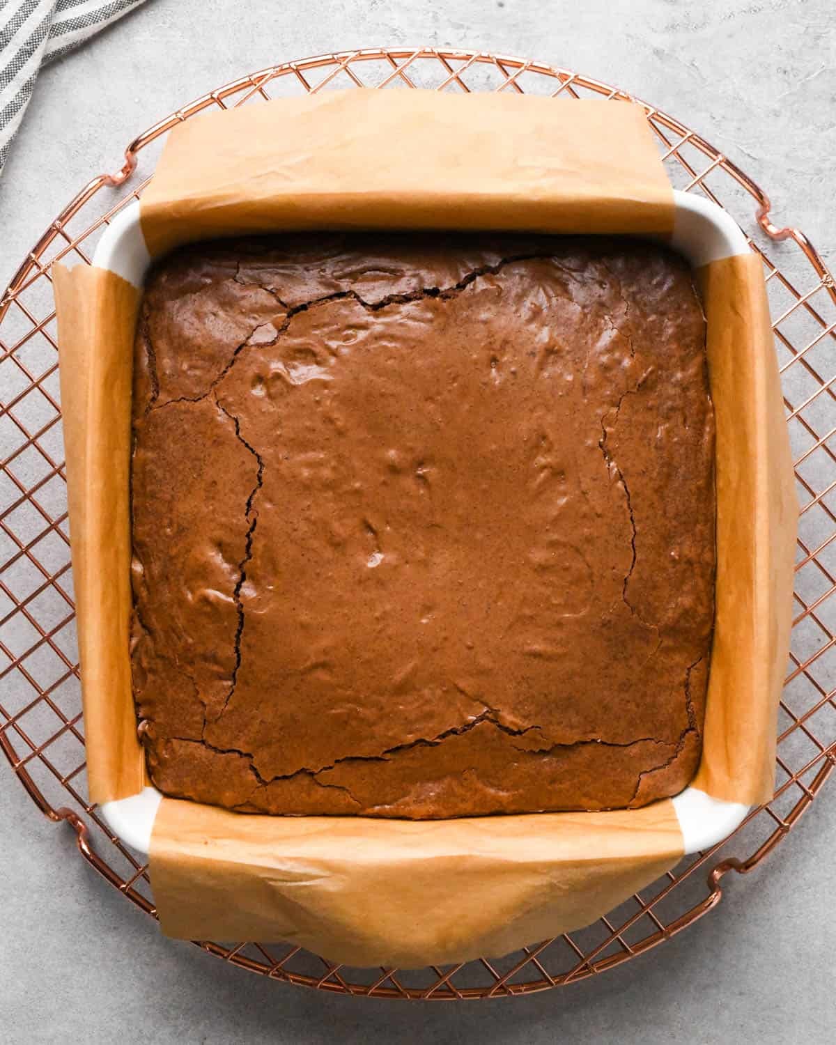 Making buckeye brownies: overhead photo of brownies in a parchment paper-lined 9x9" baking dish after they have finished baking.