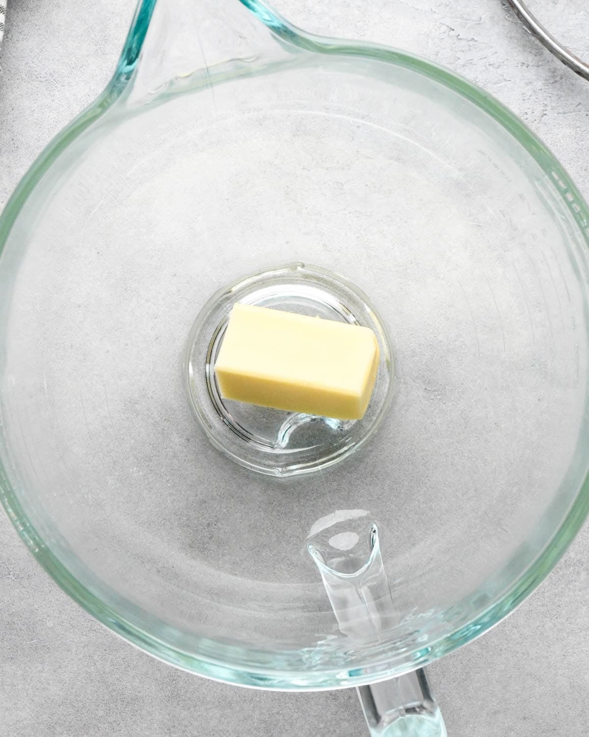 Making buckeye brownies: overhead photo of butter in a glass measuring bowl.