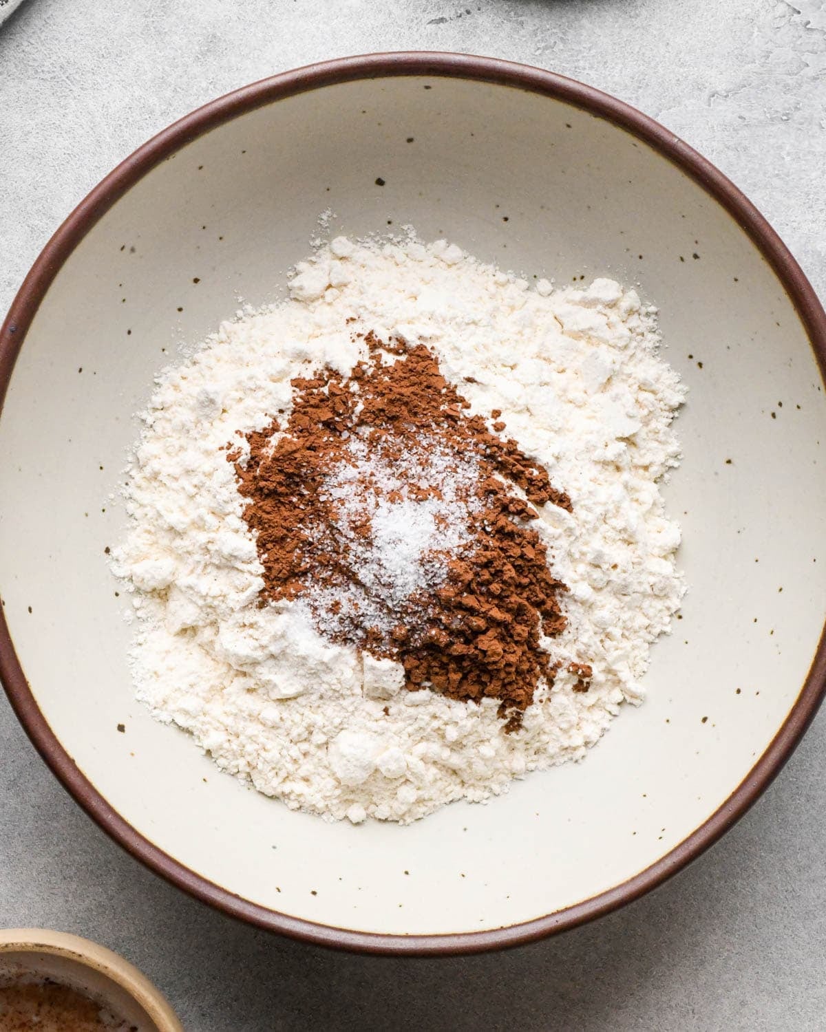 Making buckeye brownies: overhead photo of flour, salt, and cocoa powder in a small bowl.