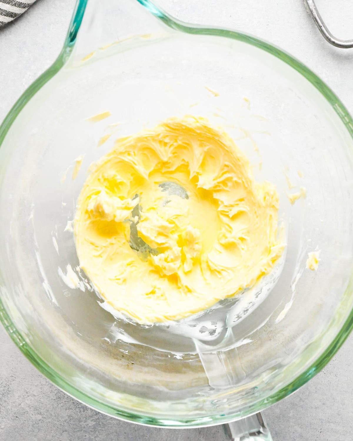 how to make raspberry frosting - beaten butter in a glass mixing bowl