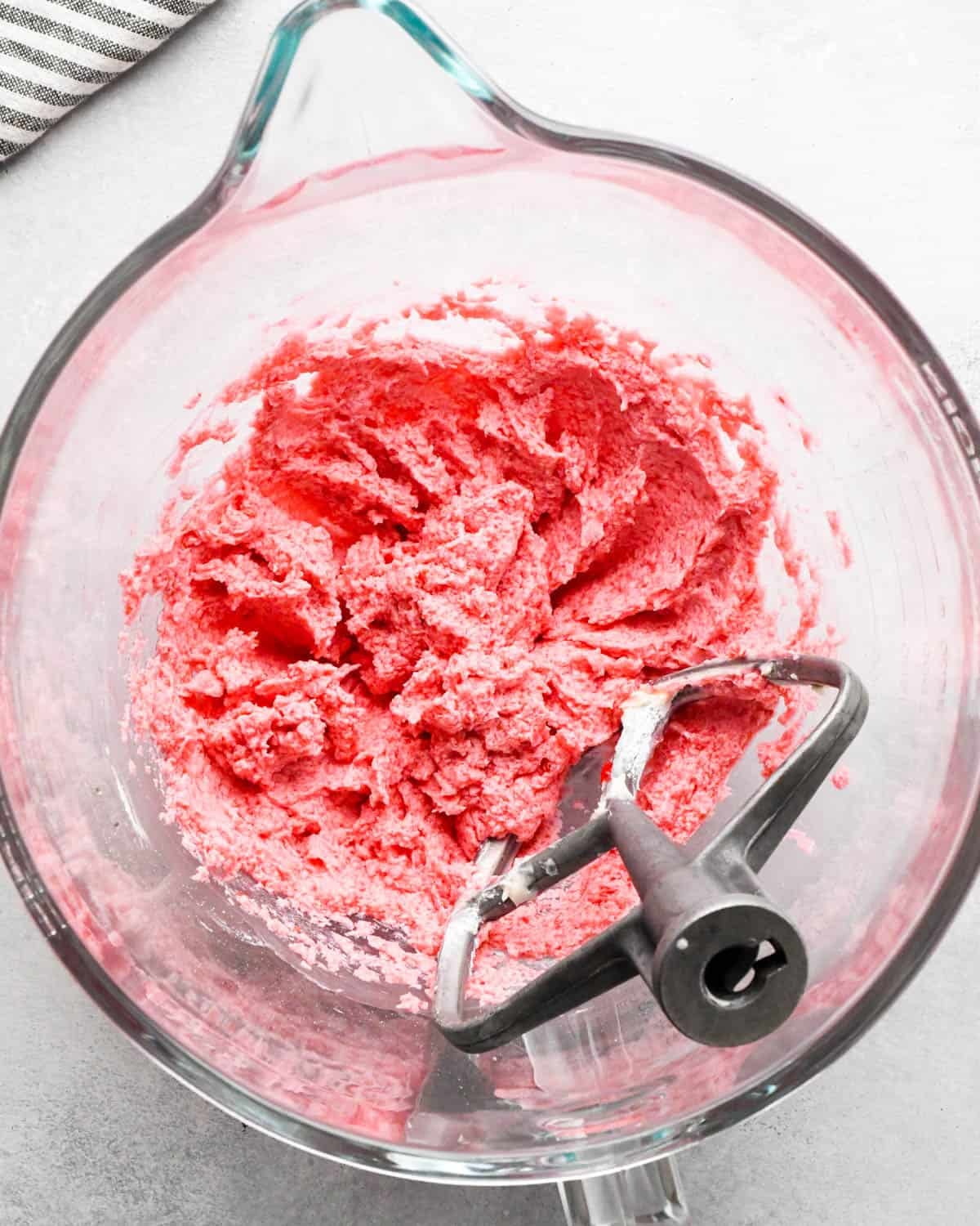 how to make raspberry frosting - ingredients after mixing with the paddle attachment in a glass bowl
