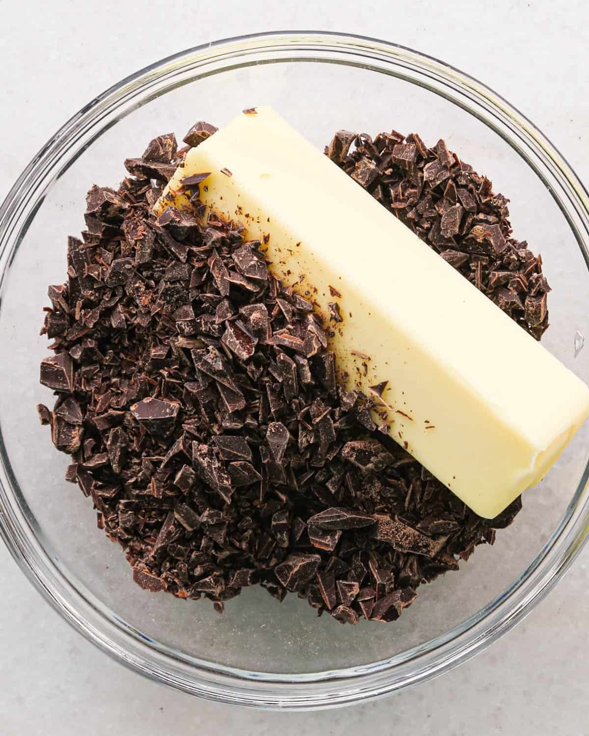 making coconut brownies - butter and chocolate in a glass bowl before melting