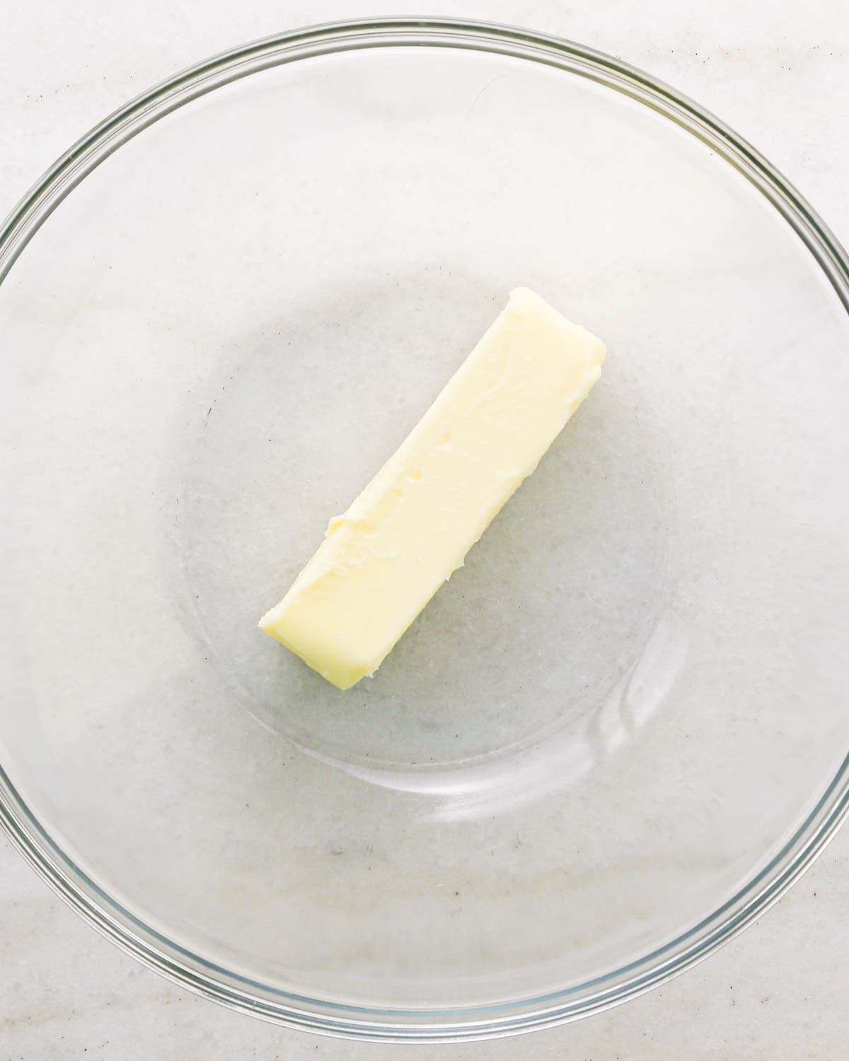 a stick of butter in a glass bowl