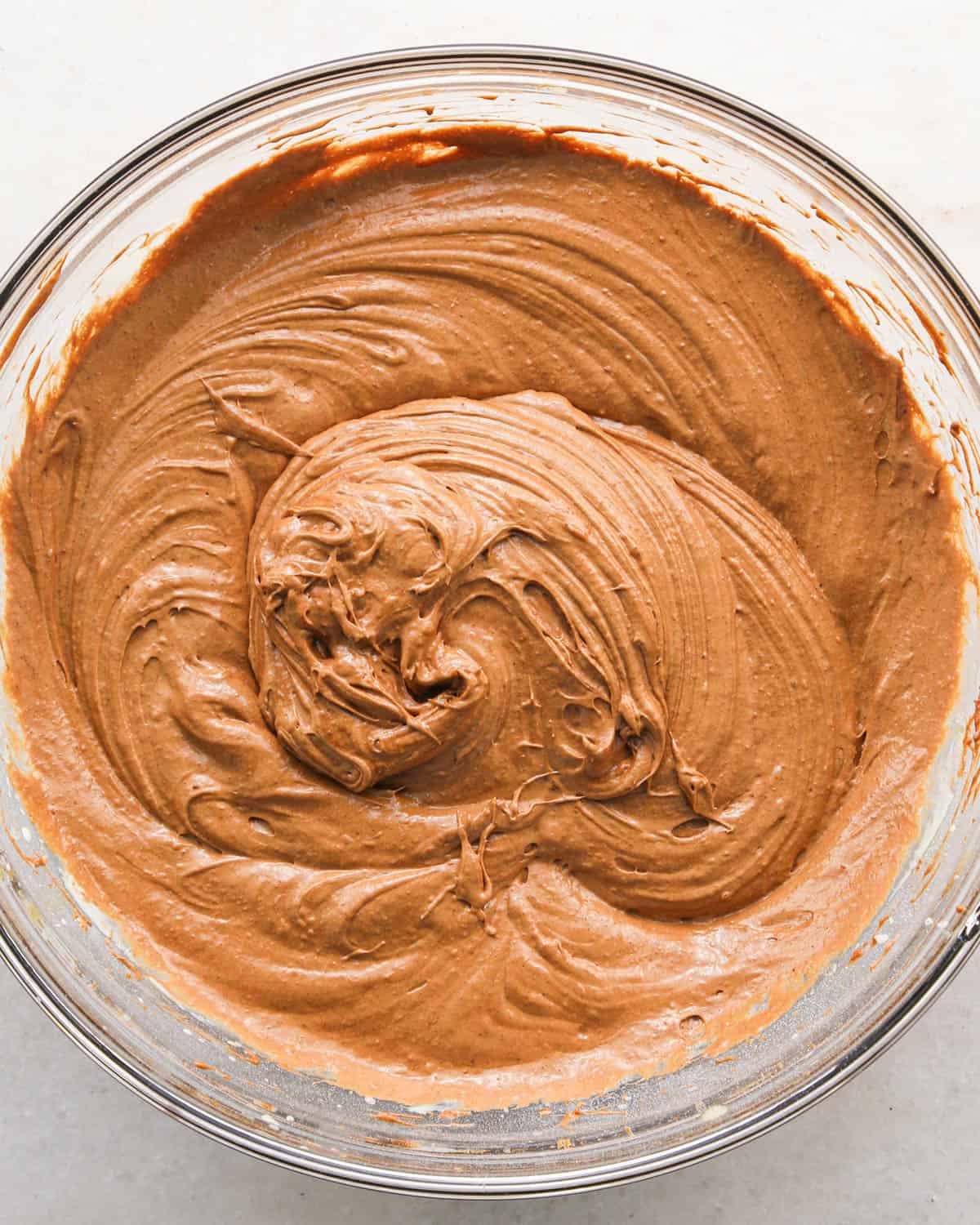 making coconut brownies - wet ingredients beaten together in a glass bowl