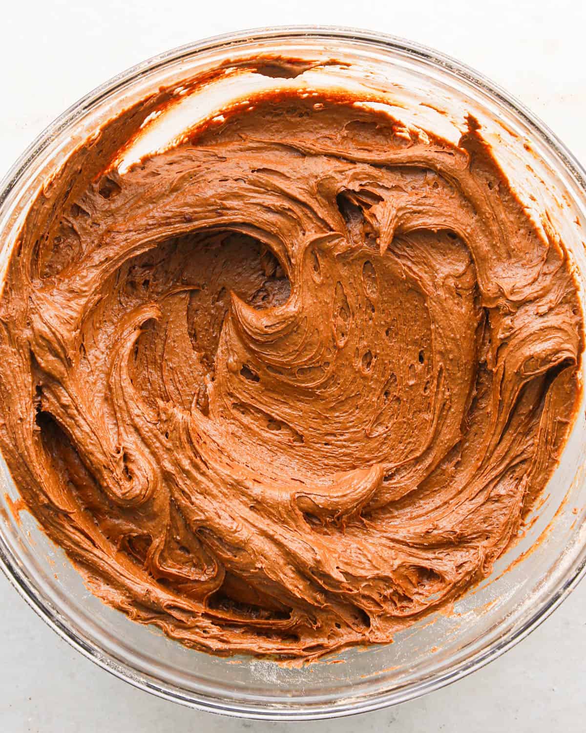 making coconut brownies - brownie batter in a glass bowl