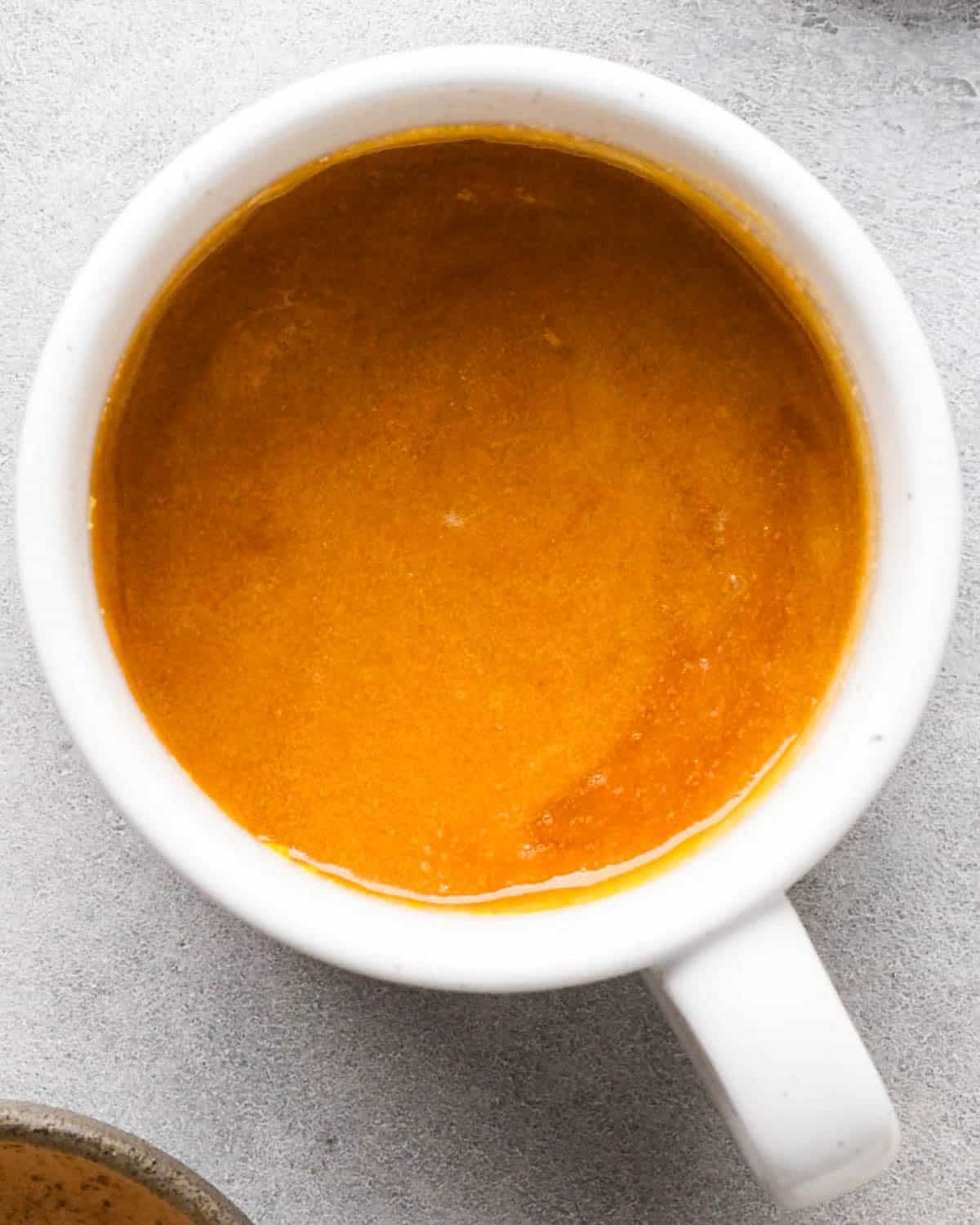 making a mug cookie - wet ingredients mixed together in a white mug