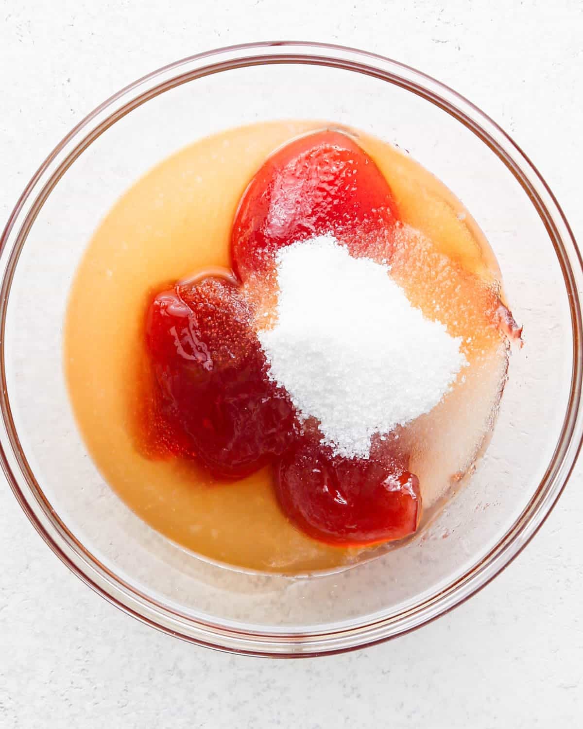 how to make a trifle with berries - jam, lemon juice and sugar in a small glass bowl before mixing