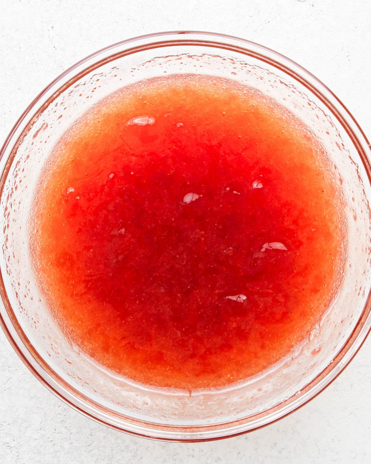 how to make a trifle with berries - jam, lemon juice and sugar in a small glass bowl after mixing