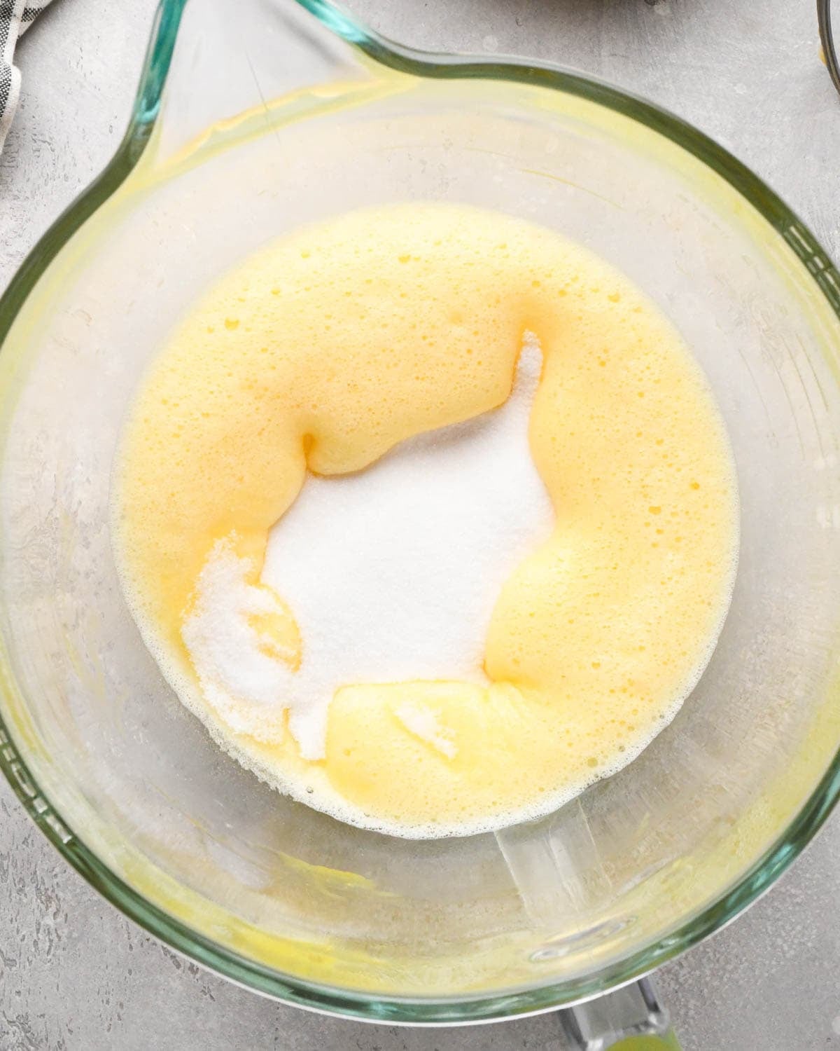 making brown butter brownies - white sugar added to beaten eggs in a glass mixing bowl