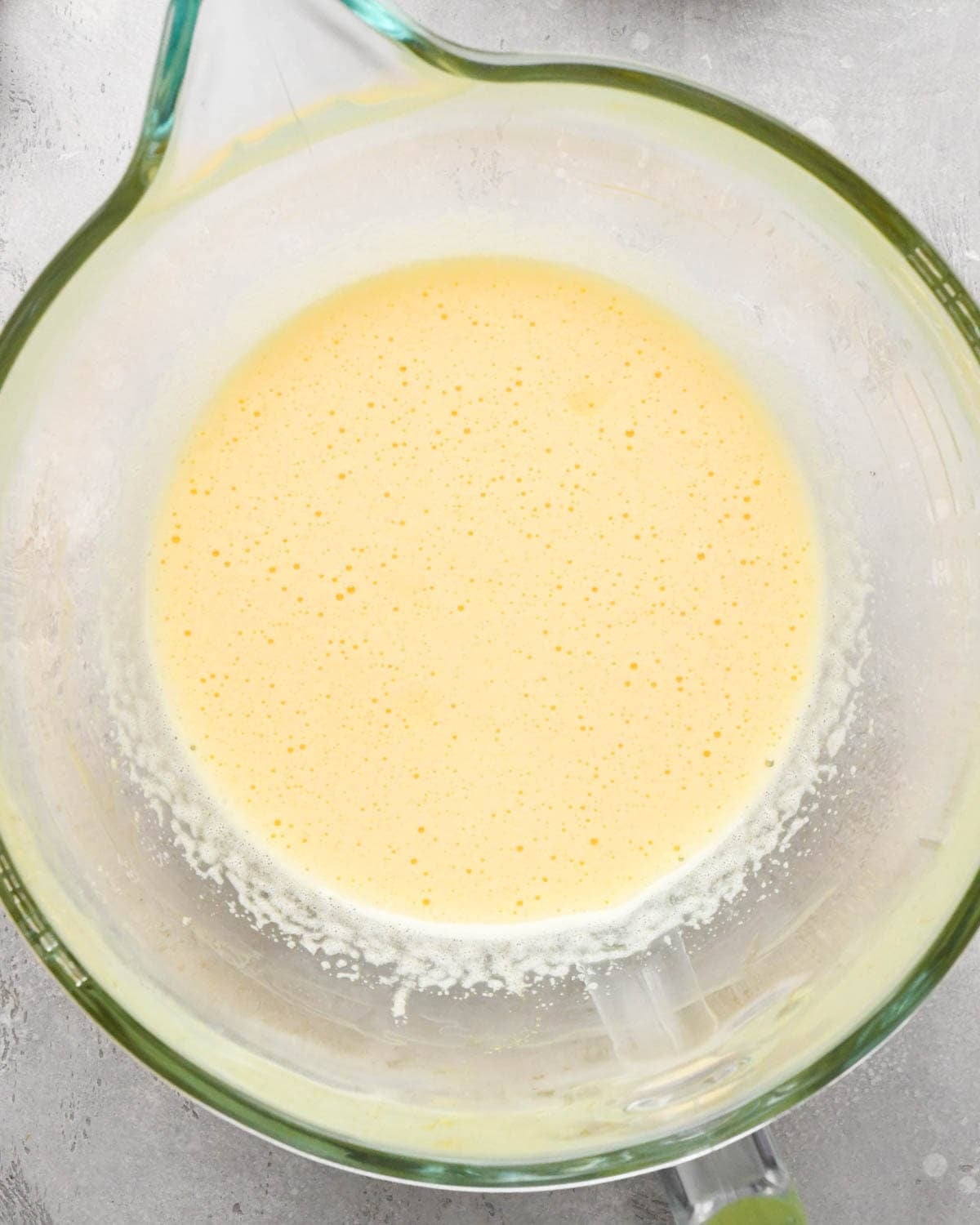 making brown butter brownies - sugar and eggs beaten together in a glass mixing bowl