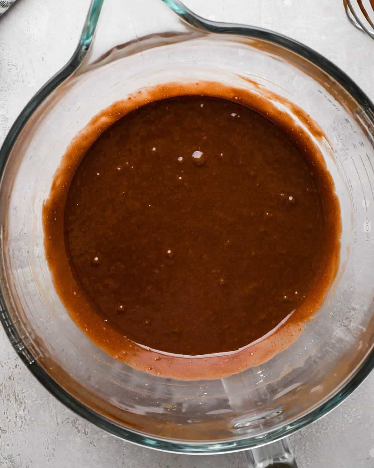 making brown butter brownies - wet ingredients combined in a glass mixing bowl