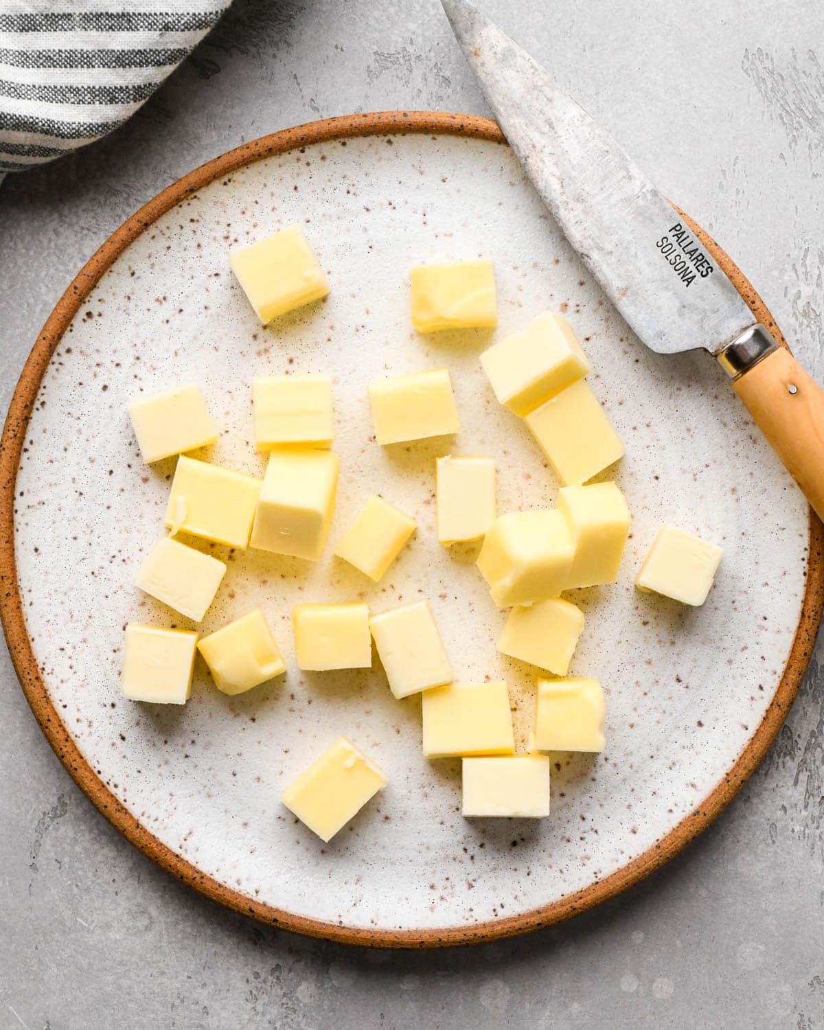 browning butter for brown butter brownies - cubed butter on a plate