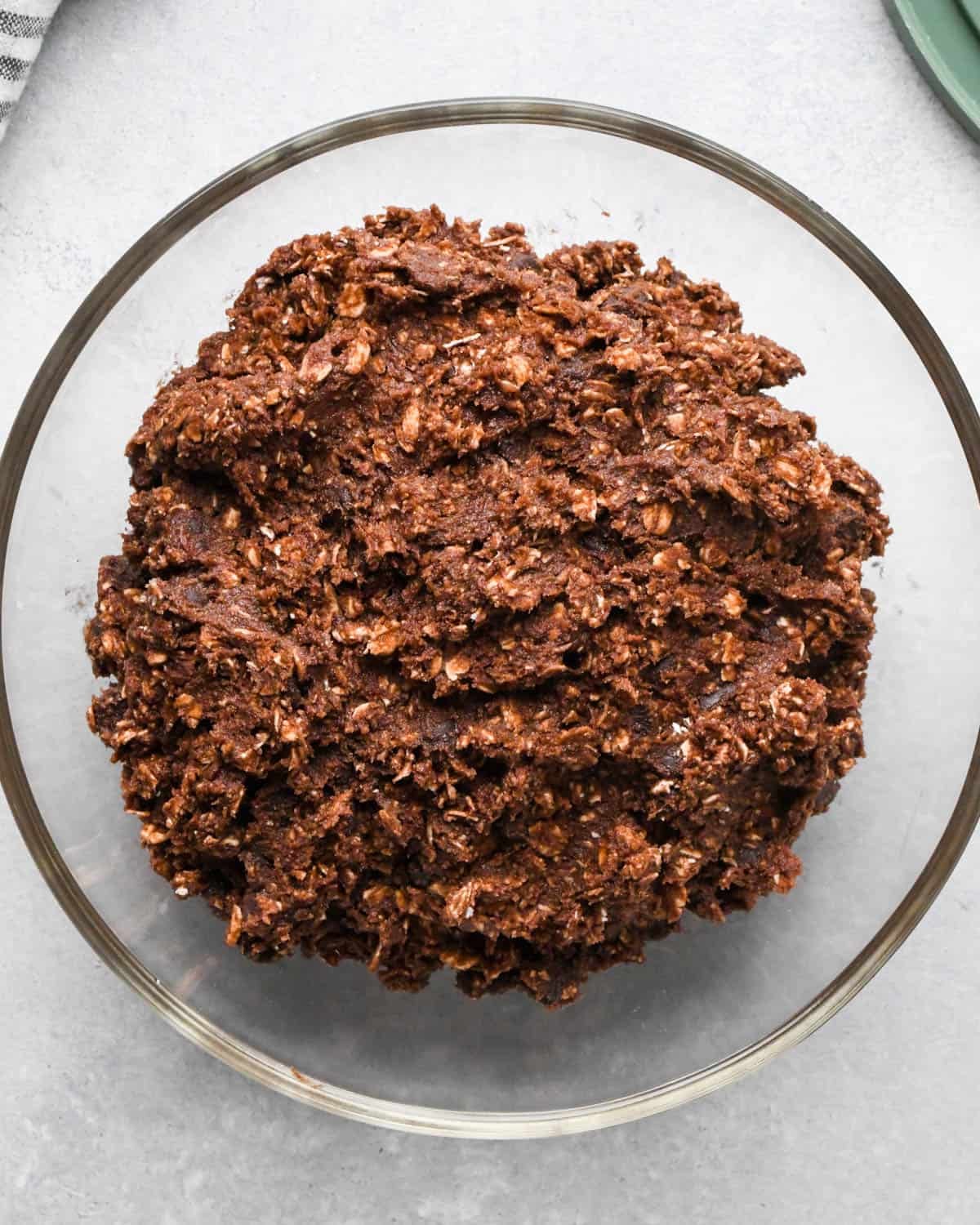 double chocolate oatmeal cookies dough in a glass bowl to be chilled in the refrigerator