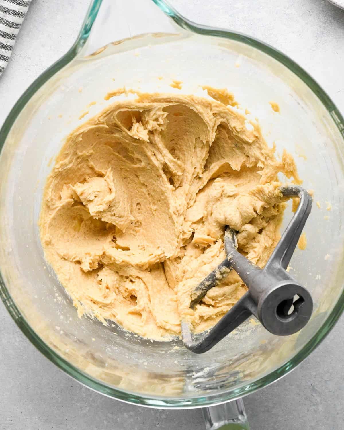 How to Make Chocolate Oatmeal Cookies - creamed wet ingredients in a glass mixing bowl with a paddle attachment