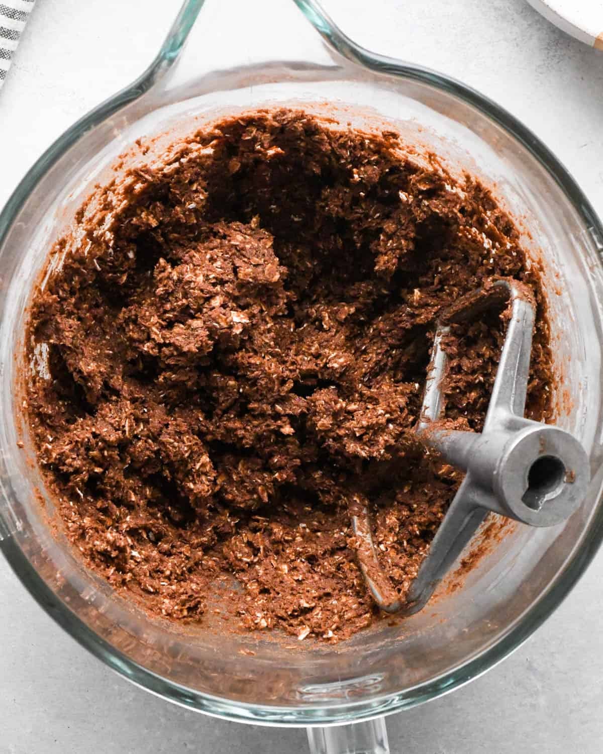 How to Make Chocolate Oatmeal Cookies - dough in a glass mixing bowl with the paddle attachment