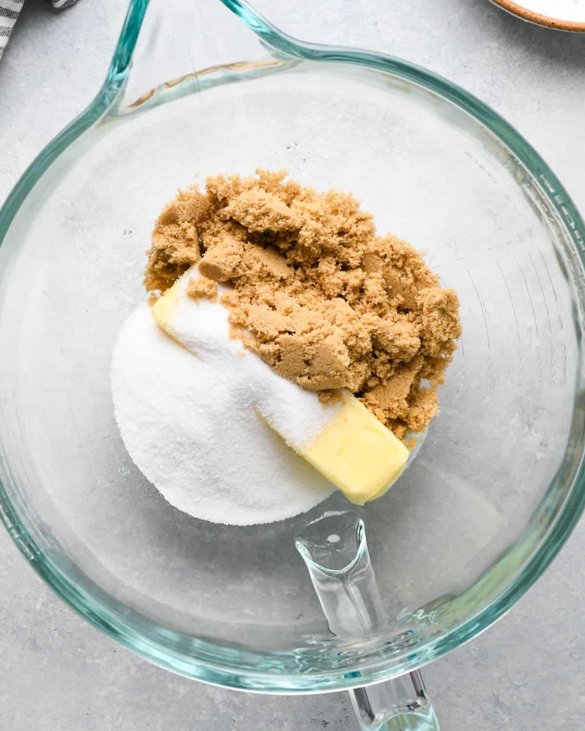 How to Make Chocolate Oatmeal Cookies - butter, sugar and brown sugar in a glass mixing bowl