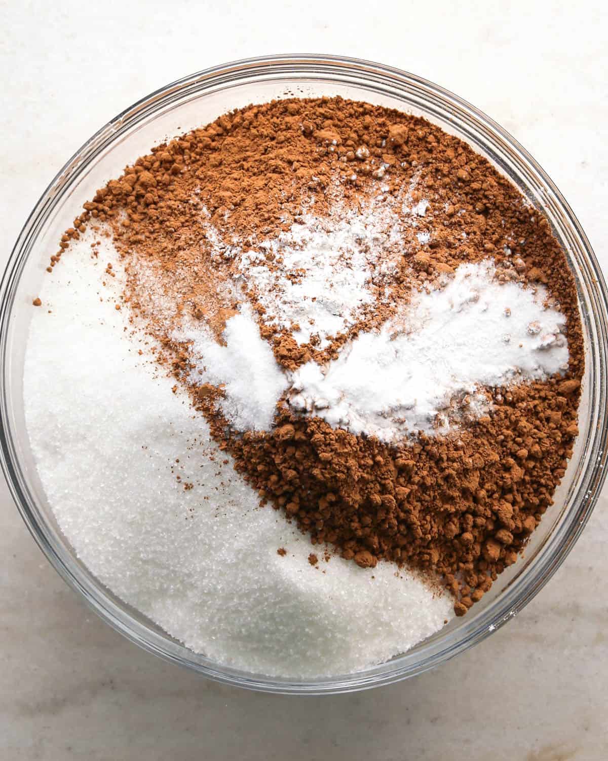 making chocolate raspberry cake - sugar, cocoa powder, flour, baking soda, baking powder and salt in a bowl before mixing