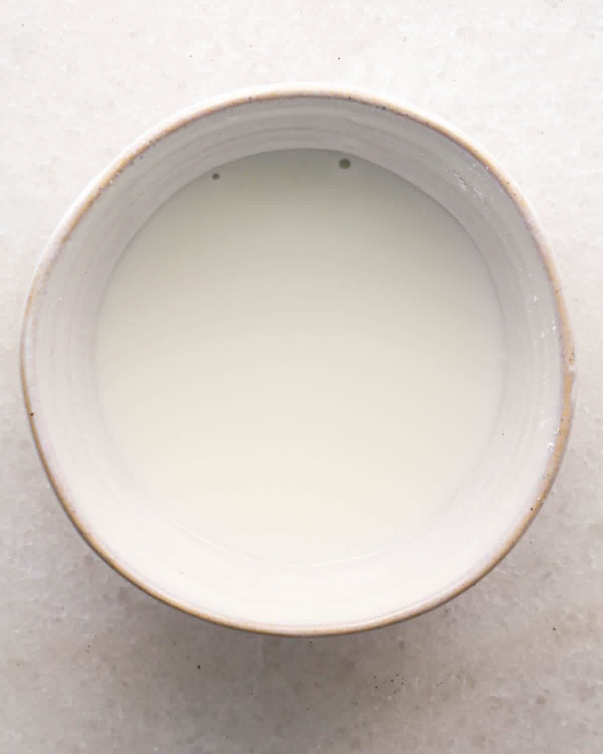 making chocolate raspberry cake filling - cornstarch and water in a small ceramic bowl after mixing