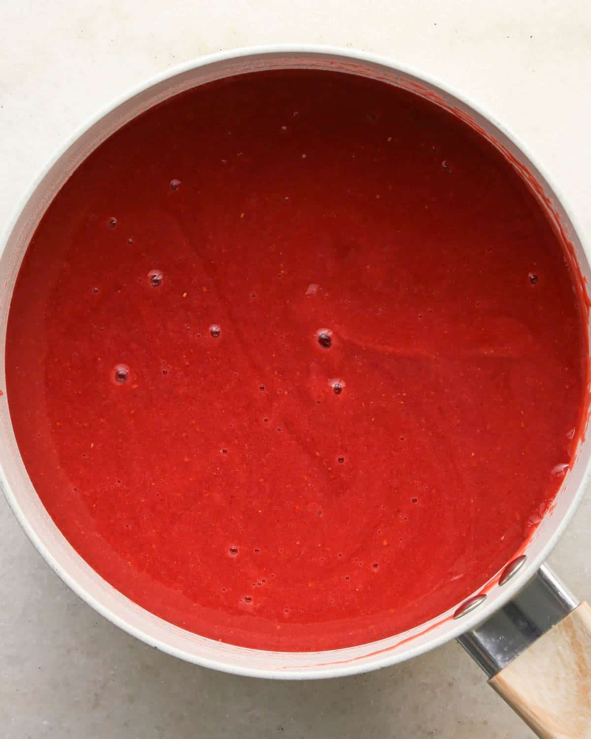 making chocolate raspberry cake filling - ingredients in a white saucepan after mixing
