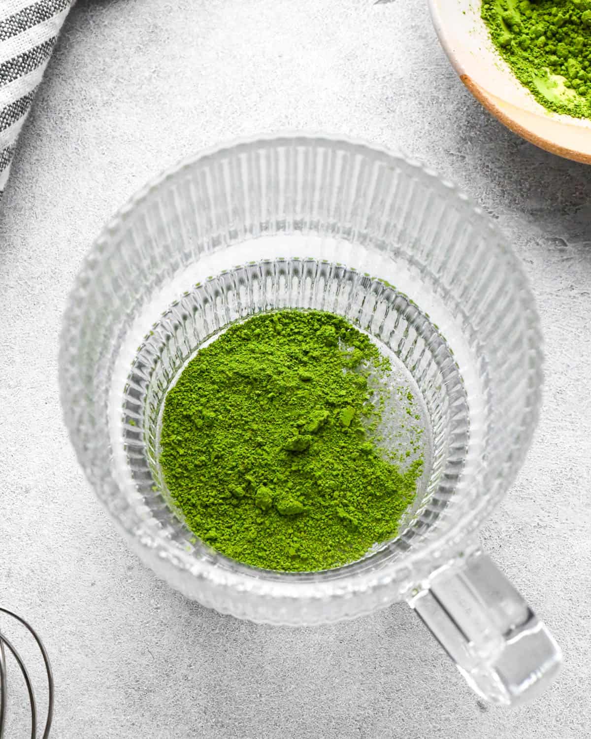 photo showing how to make a matcha latte - matcha powder in a glass mug