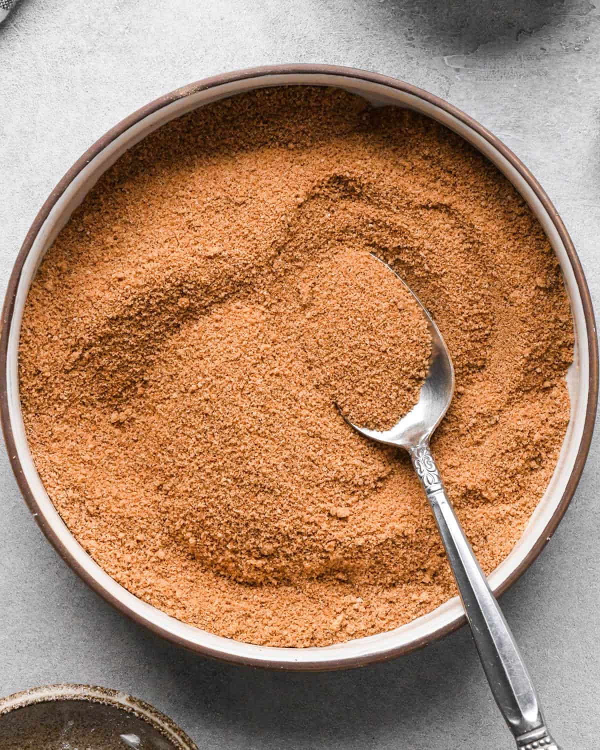 making homemade pop tarts - cinnamon brown sugar filling in a bowl with a metal spoon after mixing