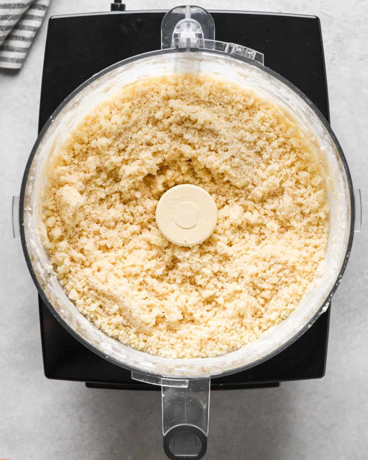 making homemade pop tarts - butter and water added to the dry ingredients in the container of a food processor fitted with the "S" blade after mixing